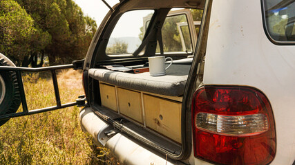 Closeup shot of a van trunk with organized shelves and a bed for sleeping © Joan Marcé Jo/Wirestock