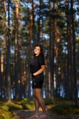 Portrait of a woman against the background of the forest. look at the camera