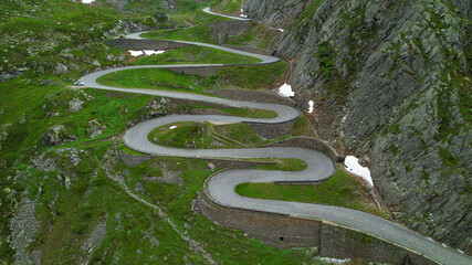 AERIAL: Aerial view of a hairpin road snaking up a mountain in Switzerland.