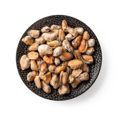 Frozen cooked mussel meat on a black textured ceramic plate isolated on a white background. Peeled mussels as ingredient of tasty seafood recipes and omega-3 protein healthy eating and.