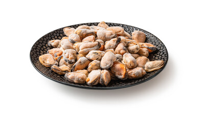 Frozen peeled mussels on a black ceramic plate isolated on a white background. Cooking shellfish. Iced mussel meat as ingredient of protein omega-3 healthy eating and tasty seafood recipes.