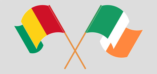 Crossed and waving flags of Guinea and Ireland