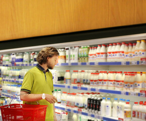 Man choosing frozen food from a supermarket freezer.