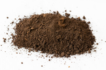 A pile of black dark brown peat, a natural fertilizer formed from particles of dead bog plants. Peat as a mineral material in natural production on white background