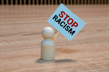 Black and white figures of people on a black background. The inscription in chalk-Stop racism.