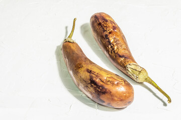 Decayed, rotten eggplant. Old vegetables with mold