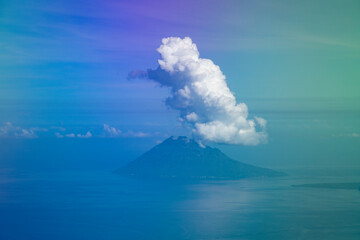 Aerial view from the plane, of the clouds clinging to the top of Manadotua Island, in Bunaken National Park, Sulawesi Island, Indonesia