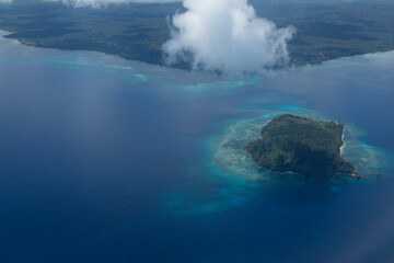 Aerial view from plane, of coastal landscape in Kapatlap area, arriving at Sorong airport in West Papua province, Indonesia