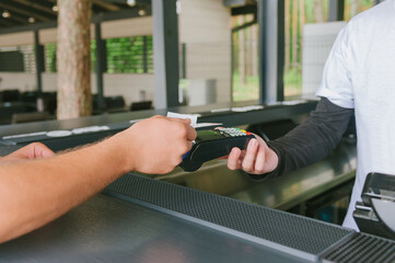 Obraz premium Close-up A man is paying by credit card through the terminal.