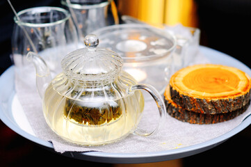 Tray with tea, glasses, sugar, candles and cup holders from the log cabins of the tree. Original tea delivery