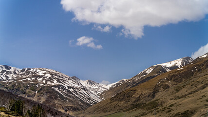 Beautiful, partially snow-capped mountains in early spring	