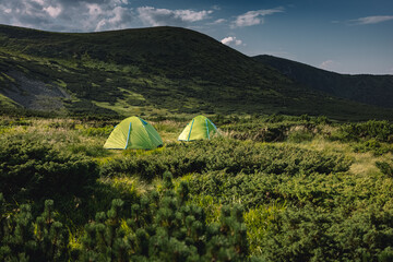 concept of vacation in the mountains. tents in the mountains. hiking in the mountains