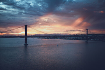 Fototapeta na wymiar incredible sunset over the big bridge. river and bridge
