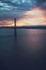 Fototapeta na wymiar incredible sunset over the big bridge. river and bridge