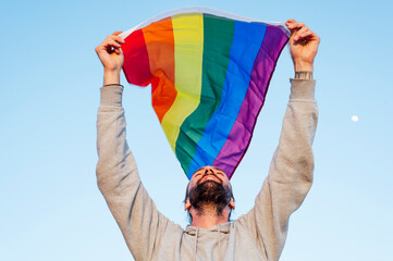Gay man waving lgbt flag