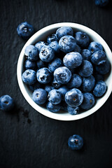 Bilberries on dark background. Top view. Close up. 