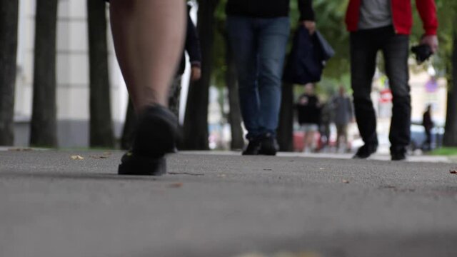Pedestrian's legs close-up. People on the urban street