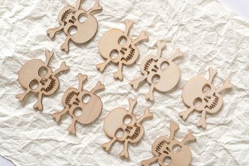 halloween themed wooden shapes arranged on crumpled ivory paper background
