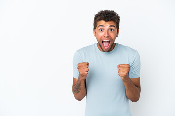 Fototapeta premium Young handsome Brazilian man isolated on white background celebrating a victory in winner position