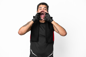 Sport brazilian man with towel isolated on white background shouting and announcing something