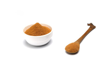 ground cinnamon in a  bowl isolated on white background, close up