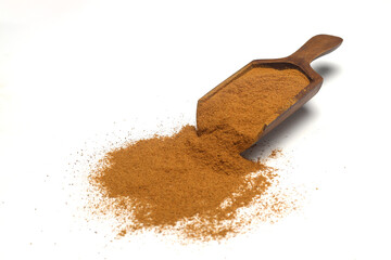 Wood scoop with cinnamon powder isolated on white background