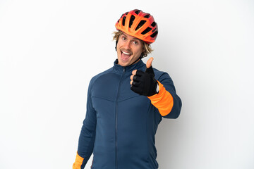 Young blonde cyclist man isolated on white background with thumbs up because something good has happened