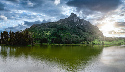 Naklejka premium Lake seen from a mountain called Pico San Pablo. It is located in Azuay, it is known as Lake Busa. The small town is observed from the mountain.