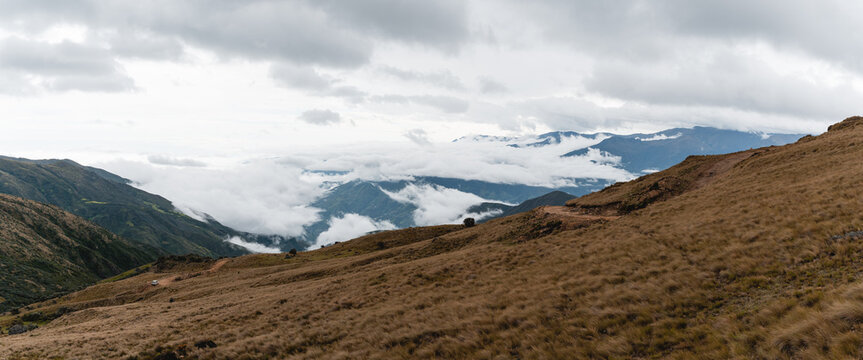 Typical mountain of the Andes, with a semi-clear and semi-cloudy sky, you can see rocks, plants, especially the straw grass that covers the hills.