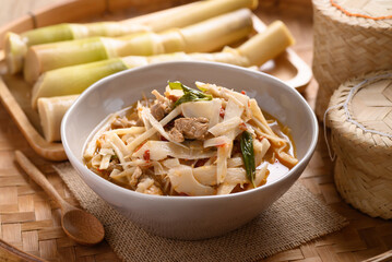 Local Thai food, Fermented bamboo shoot spicy soup with pork in a bowl on bamboo tray