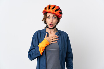 Young cyclist woman isolated on white background surprised and shocked while looking right