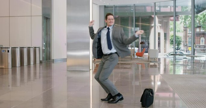 funny businessman dancing loop celebrating achievement with victory dance wearing suit corporate success