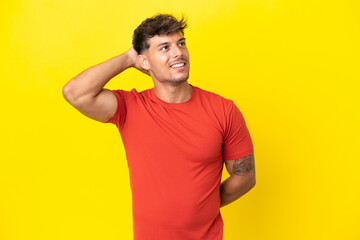 Young caucasian handsome man isolated on yellow background thinking an idea