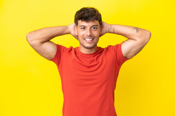 Fototapeta na wymiar Young caucasian handsome man isolated on yellow background laughing