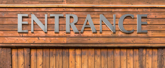 Old vintage wood grain wall surface and entrance sign to shop background. Wooden plank doorway entrance text 