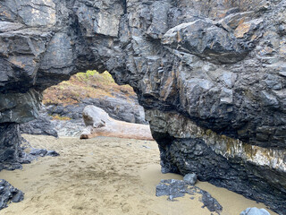 natural rock stone formation arch beach walking path trail