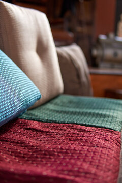 armchairs upholstered with chenille fabric, red green and blue. vertical. blurred background