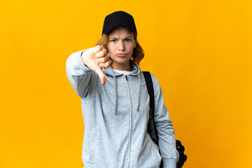 Young sport Georgian woman with sport bag over isolated background showing thumb down with negative expression