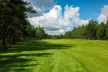 Fototapeta na wymiar Panorama view of a Golf Course with fairway field. Golf course with a rich green turf beautiful scenery. High quality photo