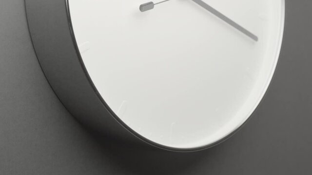 Clock Face on Dark Grey Office Wall in Timelapse