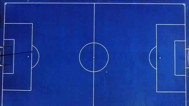Aerial view of blue artificial turf futsal field.