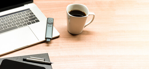 Top view coffee cup and laptop on table in meeting room