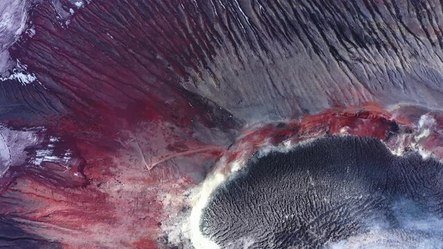 Avachinsky drone volcano summit video. Kamchatka, active volcano, red soil, steam, solidified black lava, sulfur