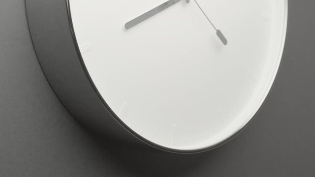 Clock Face on Dark Grey Office Wall in Timelapse