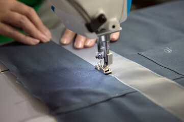 A seamstress at the factory makes knitwear.