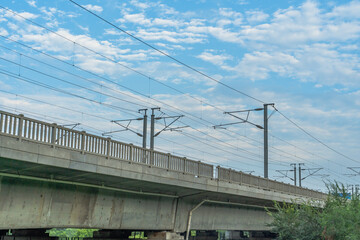 Close view of railroad bridge under blue sky.