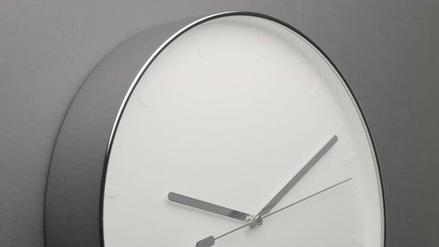 Clock Face on Dark Grey Office Wall in Timelapse