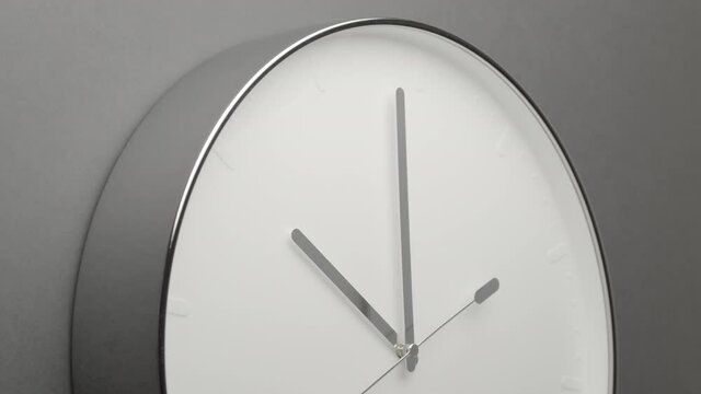 Clock Face on Dark Grey Office Wall in Timelapse
