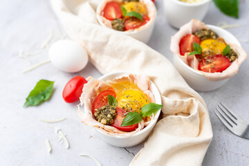 Fototapeta na wymiar Egg Caprese Breakfast Cup, hot homemade ham, egg and caprese-flavored dish