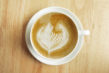 a cup of latte art coffee on wooden background                                                                                                                                                          